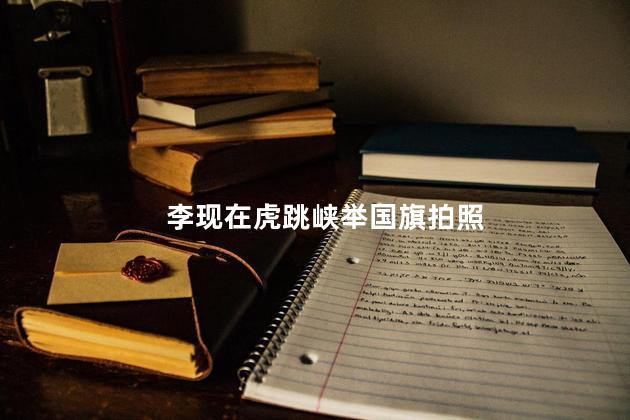 李现在虎跳峡举国旗拍照